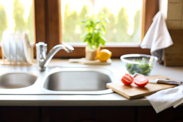 Blurred view of stylish kitchen interior with sink and products