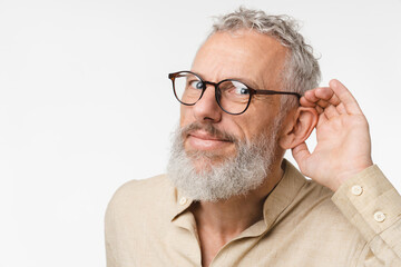 Closeup cropped curious mature middle-aged man pricking up ears, listening to gossips rumors, hand to ear isolated in white background. Secret, sale, discount