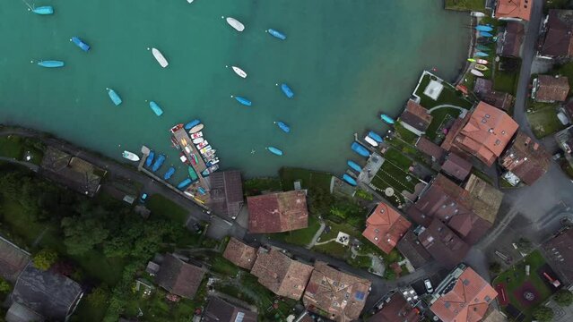 Aerial footage shot in Switzerland from a Iseltwald village located in the Swiss mountains. Lake Brienz. View from above. Top view. Europe, Swiss Alps. Drone footage 4K.
