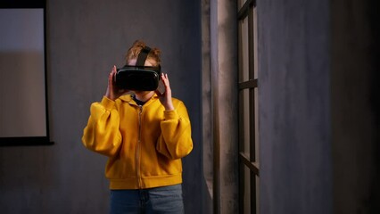 Schoolgirl wearing virtual reality goggles at school in computer science class - Powered by Adobe