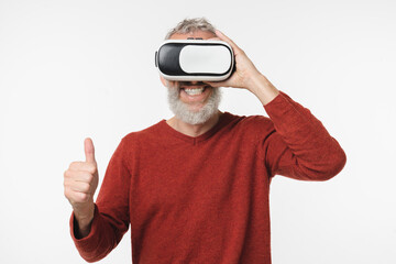 Smiling caucasian mature middle-aged man wearing VR-glasses,playing online video games showing...