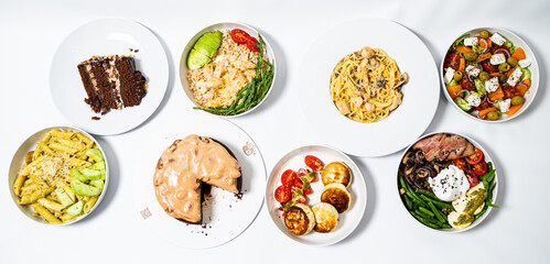 Set of festive meals of meat and vegetables and sweets on white background isolated. Menu set.