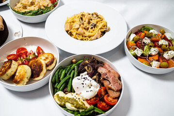 Set of festive meals of meat and vegetables and sweets on white background isolated. Menu set.