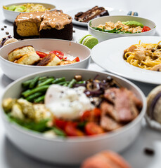 Set of festive meals of meat and vegetables and sweets on white background isolated. Menu set.