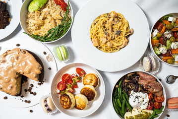 Set of festive meals of meat and vegetables and sweets on white background isolated. Menu set.