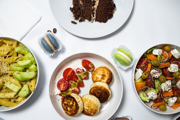 Set of festive meals of meat and vegetables and sweets on white background isolated. Menu set.