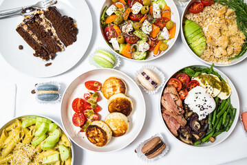 Set of festive meals of meat and vegetables and sweets on white background isolated. Menu set.