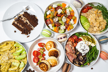 Set of festive meals of meat and vegetables and sweets on white background isolated. Menu set.