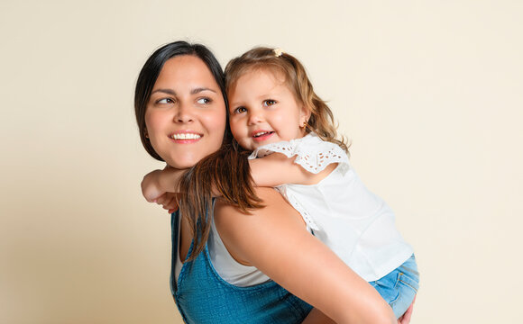 Mother with his daughter on studio white background