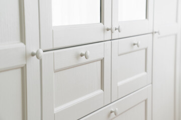 Obraz premium White built-in wardrobe with mirrors. storage and order in the apartment. 