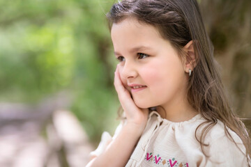 Fototapeta premium cute toddler girl five years outside in forest