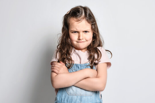 Not impressed with you. Studio shot of a little girl not happy of the situation