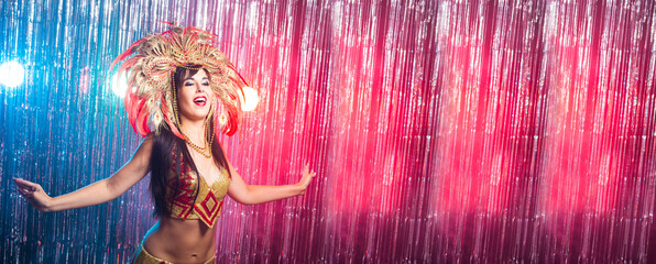 Banner carnival dancer and holiday concept - Beauty brunette woman in cabaret suit and headdress with natural feathers and rhinestones.