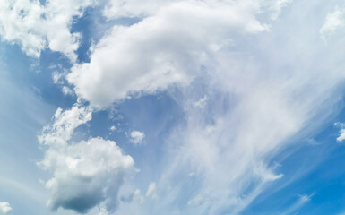 Beautiful wave of white cirrus and cumulus clouds in blue sky. Natural sky space.