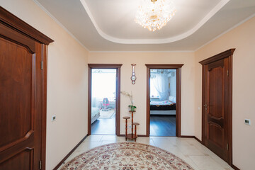 entrance hall with interior doors made of brown wood. 