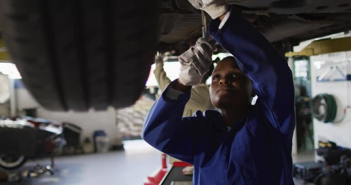 Video of african american female car mechanic repairing car