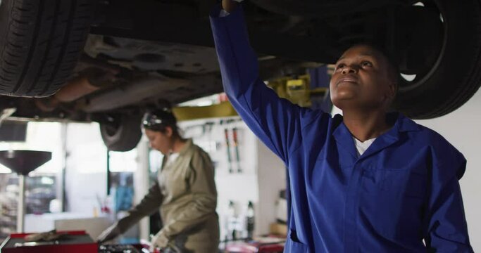 Video of african american female car mechanic checking car
