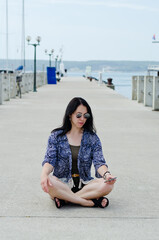 Fototapeta premium Portrait of young happy brunette woman in sunglasses relaxing at the seaside, beach at Adriatic sea. Summer vacation. Travel. Trip