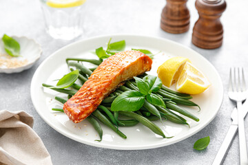 Grilled salmon fish fillet and green beans with lemon and basil