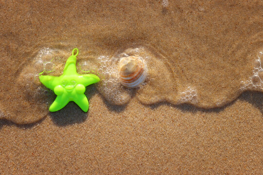 Top view image of sandy summer beach and plastic star fish