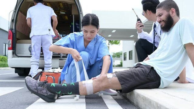 First aid assistance of the ambulance medical team with CPR method and hand-squeezed breathing apparatus