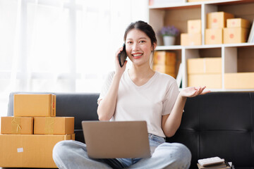 Business digital online SME small business a new startup in the present for an online shop. Happy Young Asian woman have a warehouse used to send a customer Entrepreneur owner SME or freelance concept