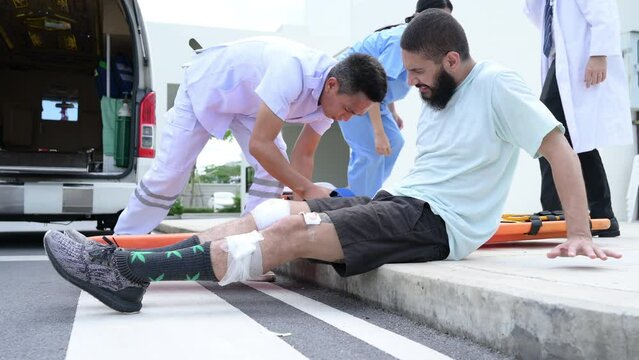 First aid assistance of the ambulance medical team with CPR method and hand-squeezed breathing apparatus