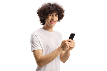 Fototapeta premium Casual young man with a curly hair using a smartphone and looking at camera