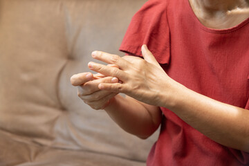 Senior woan massage finger with painful swollen gout inflammation