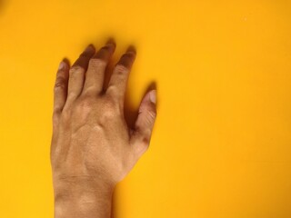 hand of a person isolated on orange background