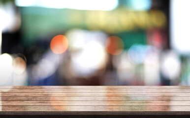 Fototapeta premium Empty wooden table top with lights bokeh on blur restaurant background. 