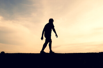 Silhouettes of men running happily in the evening. Travel and fitness concept