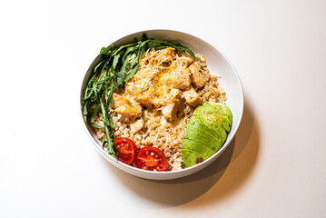 Food porridge with vegetables in a plate on a white background