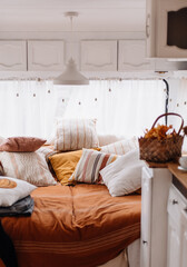 bed in trailer house. vintage style. cozy sleeping place with many pillows