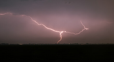 Naklejka na ściany i meble Powerful lightning strike at night in heavy rain