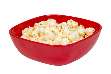Macro close up of popped popcorn kernels in a red bowl with a shallow depth of field isolated on white
