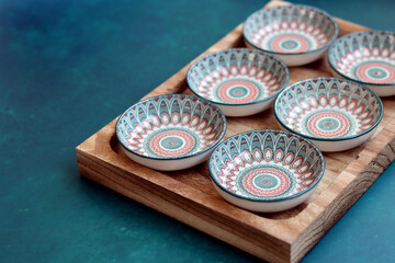Oriental ceramic plates with mandala motif. Ethnic dishware close up photo. Authentic Arabian...
