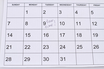 Tax time handwritting on the 9th paper calendar day. Planning and time management concept.