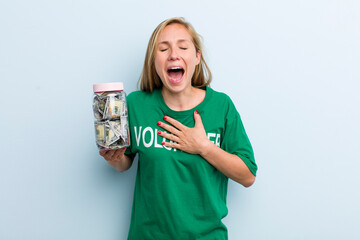 young adult blonde woman laughing out loud at some hilarious joke. volunteer and donation concept