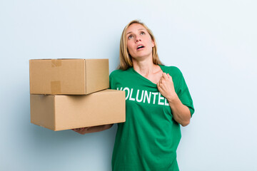 young adult blonde woman feeling stressed, anxious, tired and frustrated. volunteer and donation...