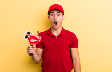 young handsome guy looking very shocked or surprised. packer emnployee concept