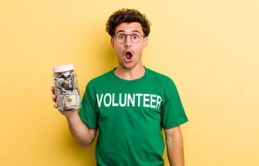 young handsome guy looking very shocked or surprised. donation and volunteer concept