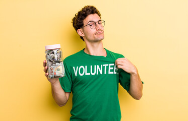 young handsome guy looking arrogant, successful, positive and proud. donation and volunteer concept