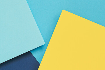 Abstract color papers geometry flat lay composition banner background with light blue and pastel yellow tones