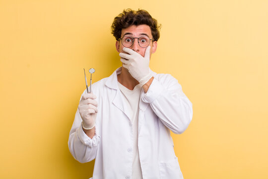 young handsome guy covering mouth with hands with a shocked. dentist concept