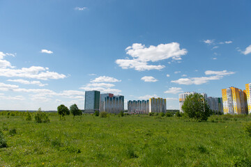 Fototapeta na wymiar view of the residential complex from a clear field
