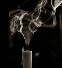 a white extinguished candle, with smoke