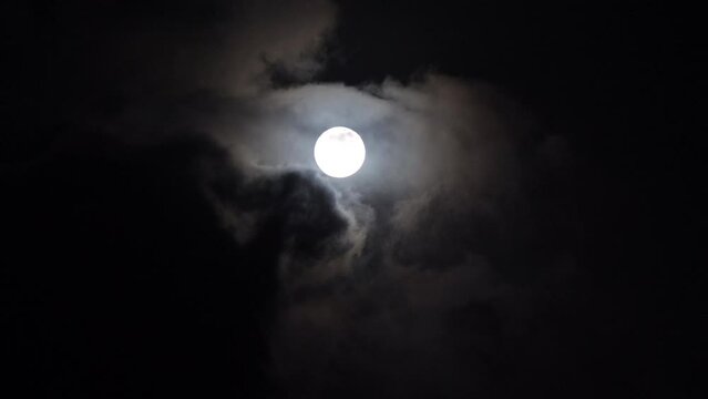 Full moon light through clouds at night