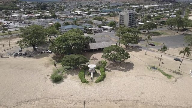 Aerial view of lifeguard station in Pokai bay revealing Waianae homes