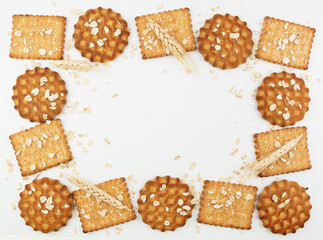 Healthy and delicious cookies and crackers. Oats and wheat on the background. copy space frame for recipes with spikelets